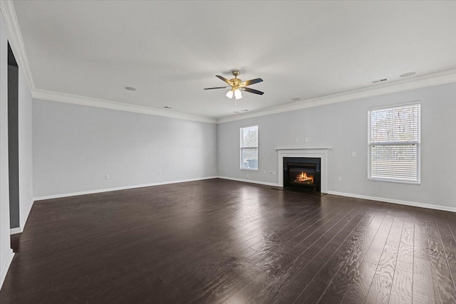 unfurnished living room with ceiling fan, a wealth of natural light, ornamental molding, and dark hardwood / wood-style floors