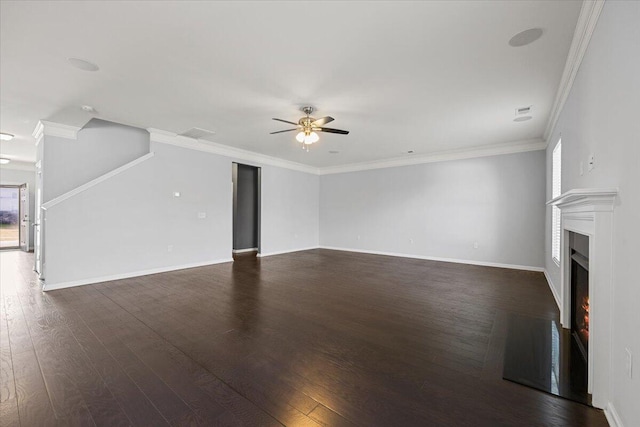 unfurnished living room with dark hardwood / wood-style floors, ceiling fan, crown molding, and plenty of natural light