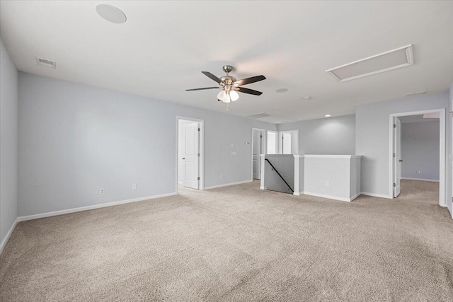 spare room with ceiling fan and light colored carpet