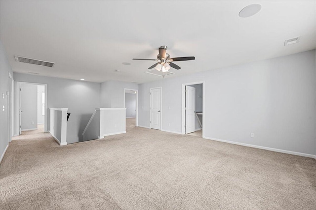 empty room with ceiling fan and light colored carpet