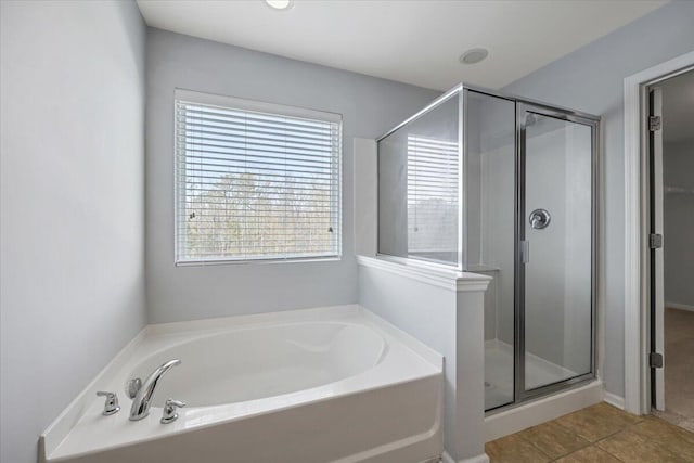 bathroom featuring tile patterned flooring and separate shower and tub