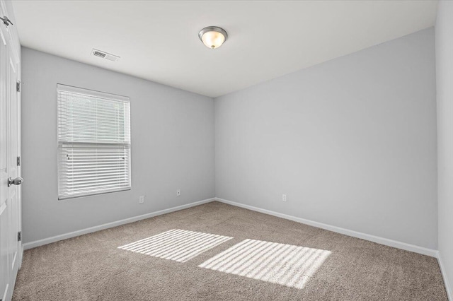 unfurnished room with light carpet