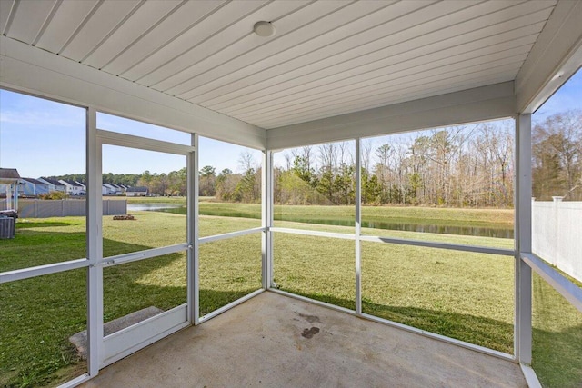 unfurnished sunroom with a water view