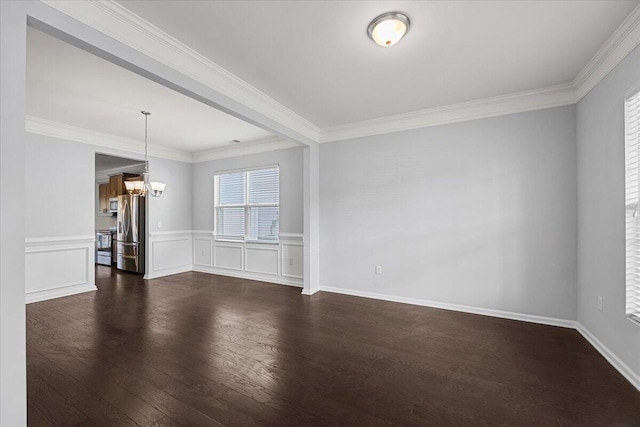 spare room with an inviting chandelier, ornamental molding, and plenty of natural light