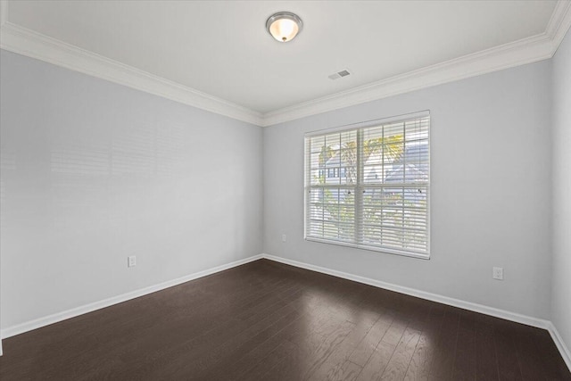 empty room featuring dark wood-type flooring and crown molding