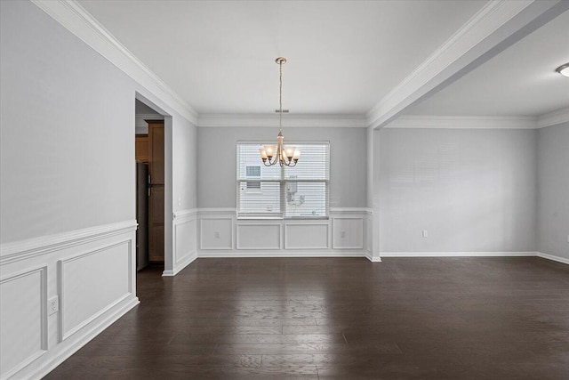 unfurnished dining area featuring dark wood-type flooring, crown molding, and a notable chandelier