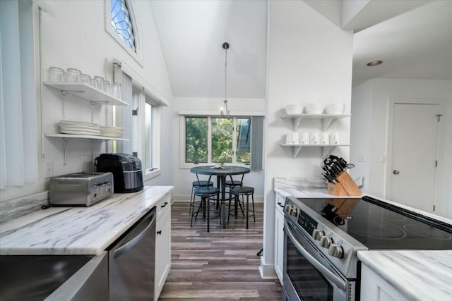 kitchen featuring appliances with stainless steel finishes, dark hardwood / wood-style flooring, light stone counters, vaulted ceiling, and white cabinets