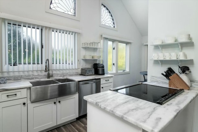 kitchen featuring vaulted ceiling, white cabinetry, a healthy amount of sunlight, and sink