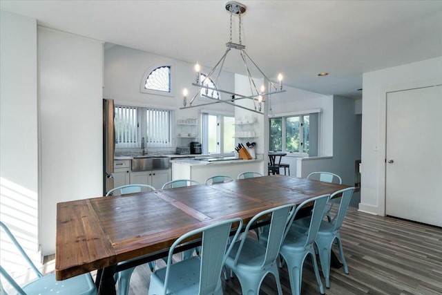 dining room featuring dark hardwood / wood-style flooring, sink, and a chandelier