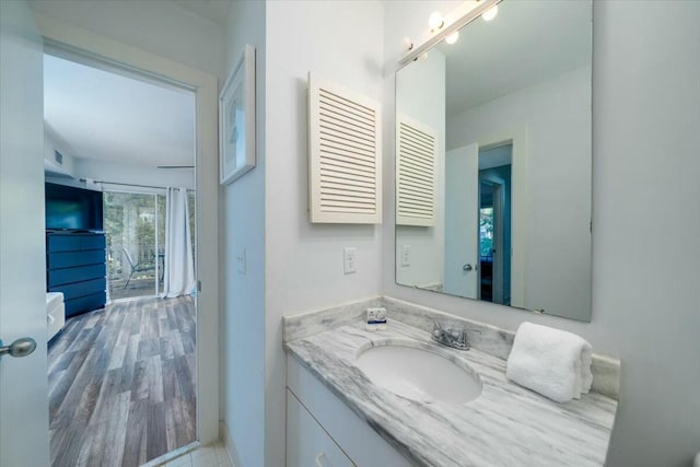 bathroom with hardwood / wood-style floors and vanity