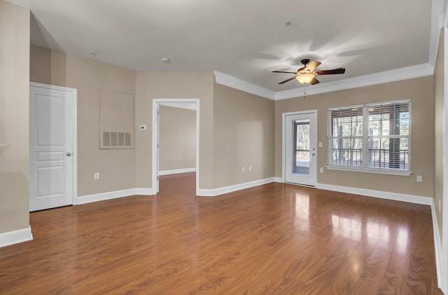 spare room with ceiling fan, baseboards, and wood finished floors