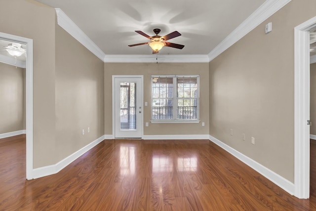 spare room with dark wood-style floors, ceiling fan, baseboards, and crown molding