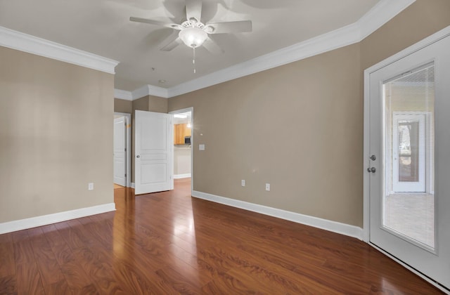 spare room featuring crown molding, ceiling fan, wood finished floors, and baseboards