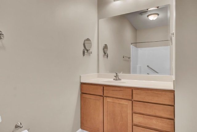 full bath featuring a shower and vanity