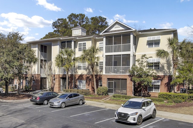 view of building exterior featuring uncovered parking