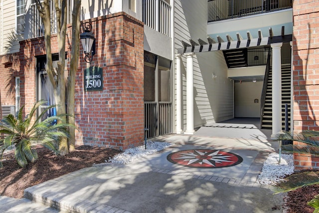 property entrance featuring brick siding