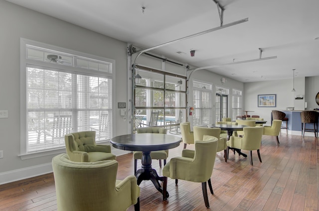 dining space featuring plenty of natural light, wood finished floors, and baseboards