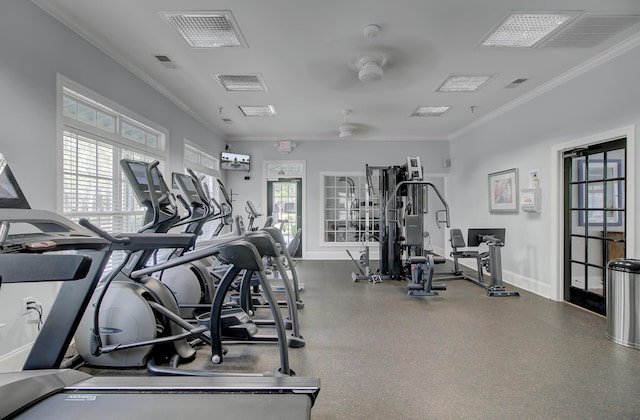 exercise room featuring visible vents, baseboards, and crown molding