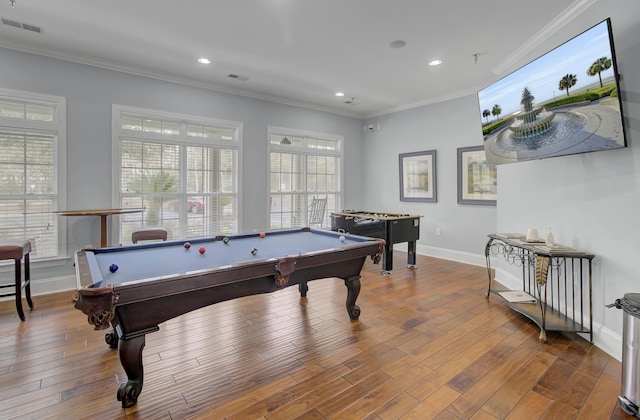 rec room with wood-type flooring, visible vents, crown molding, and baseboards