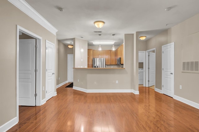 unfurnished living room with baseboards and wood finished floors