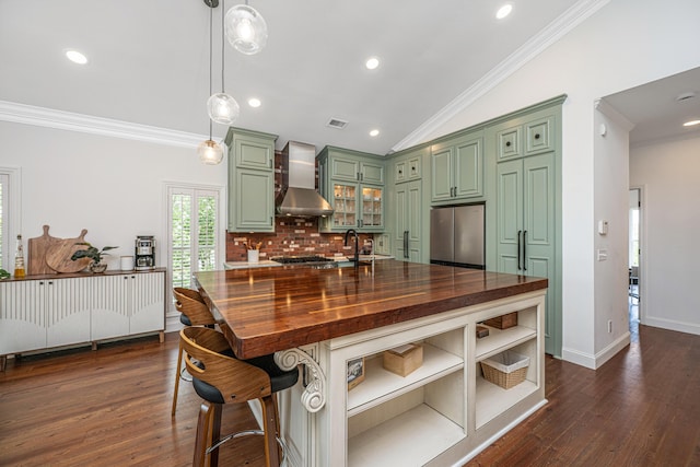 1520 Regimental Ln, Johns Island, SC 29455 - kitchen featuring green cabinets, wall chimney exhaust hood, butcher block countertops, freestanding refrigerator, and crown molding