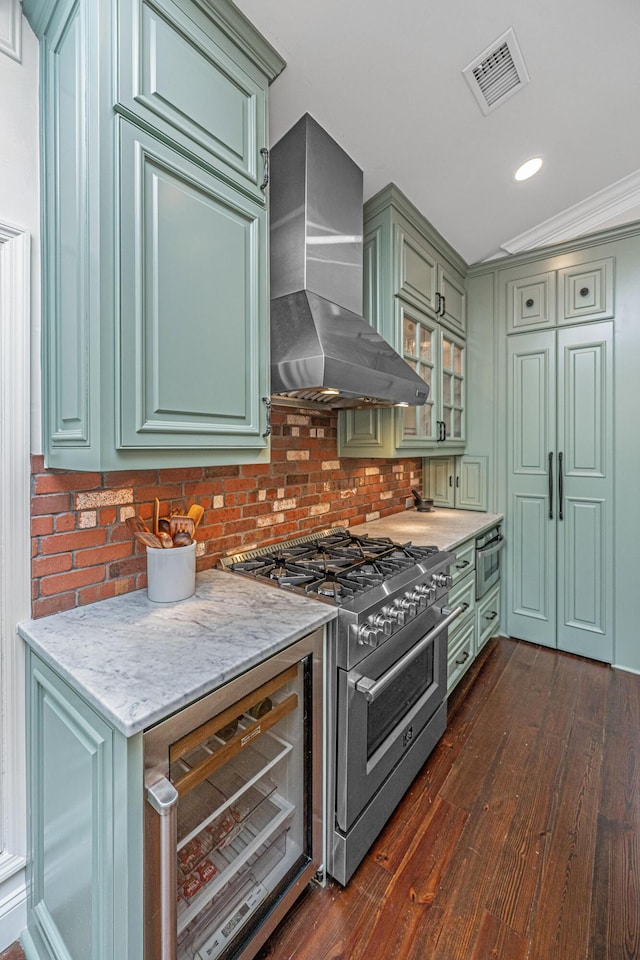1520 Regimental Ln, Johns Island, SC 29455 - kitchen featuring wall chimney exhaust hood, high end stove, green cabinets, dark wood-style floors, and recessed lighting