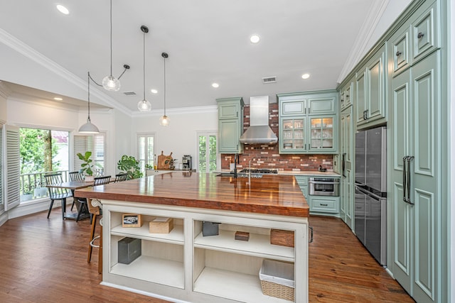 1520 Regimental Ln, Johns Island, SC 29455 - kitchen featuring wall chimney range hood, green cabinets, wood counters, freestanding refrigerator, and open shelves