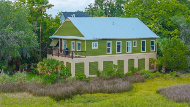 1520 Regimental Ln, Johns Island, SC 29455 - back of house featuring a metal roof and stucco siding