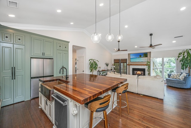 1520 Regimental Ln, Johns Island, SC 29455 - kitchen with green cabinets, a ceiling fan, lofted ceiling, a lit fireplace, and ornamental molding