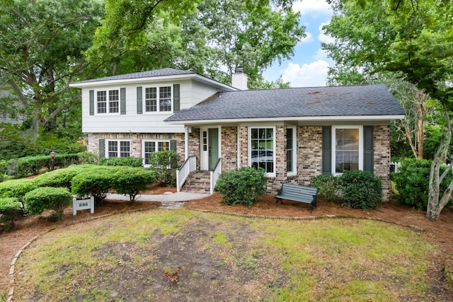 886 Friendly Cir, Charleston, SC 29414 - split level home featuring a chimney, brick siding, and roof with shingles