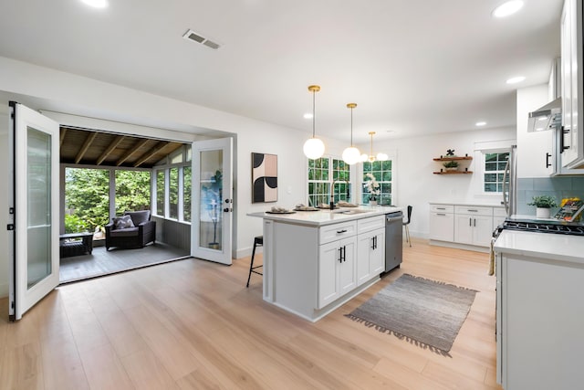 886 Friendly Cir, Charleston, SC 29414 - kitchen featuring stainless steel dishwasher, a sink, white cabinets, open shelves, and light countertops
