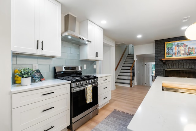 886 Friendly Cir, Charleston, SC 29414 - kitchen featuring stainless steel range with gas stovetop, wall chimney exhaust hood, light countertops, white cabinetry, and recessed lighting