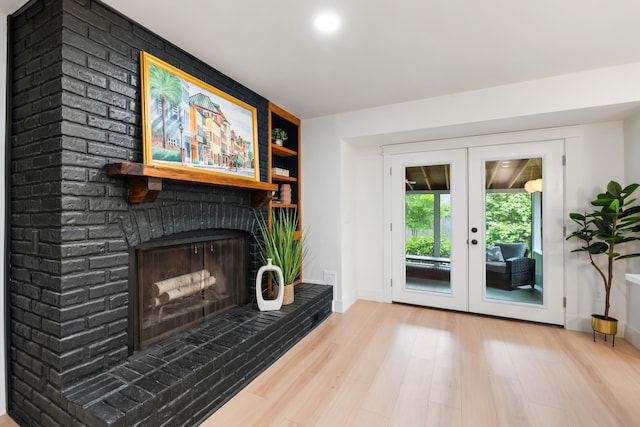 886 Friendly Cir, Charleston, SC 29414 - living area featuring french doors, wood finished floors, a brick fireplace, built in features, and baseboards
