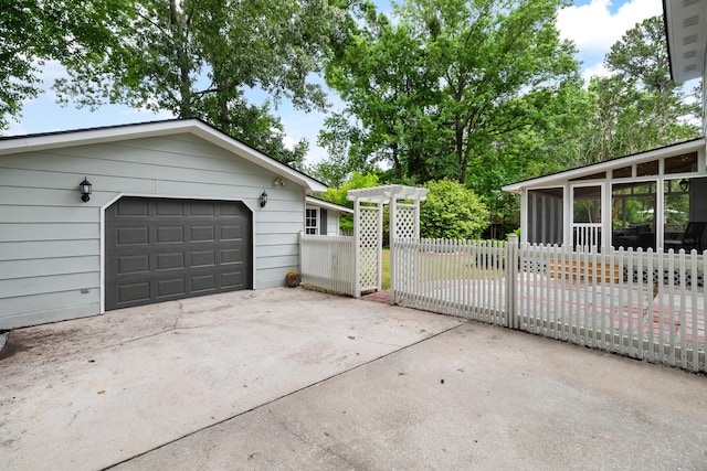 886 Friendly Cir, Charleston, SC 29414 - view of side of home with a sunroom, a garage, and concrete driveway