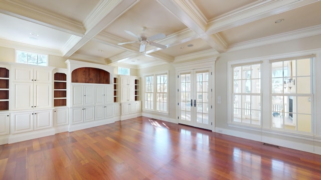 interior space with plenty of natural light, hardwood / wood-style floors, beam ceiling, and french doors