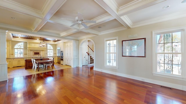 dining space with beamed ceiling, plenty of natural light, and light hardwood / wood-style flooring