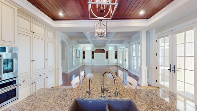 kitchen with sink, wood ceiling, hanging light fixtures, french doors, and cream cabinetry