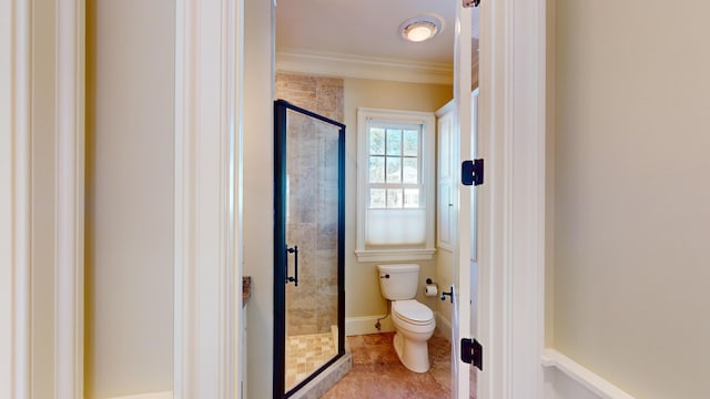 bathroom with crown molding, tile patterned floors, toilet, and walk in shower