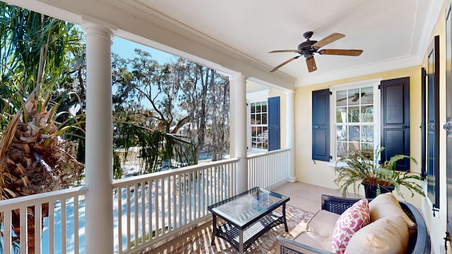 sunroom / solarium featuring ceiling fan