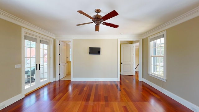 spare room with french doors, ceiling fan, wood-type flooring, and crown molding