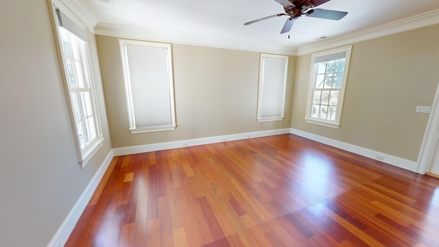 empty room with hardwood / wood-style flooring, ornamental molding, and ceiling fan