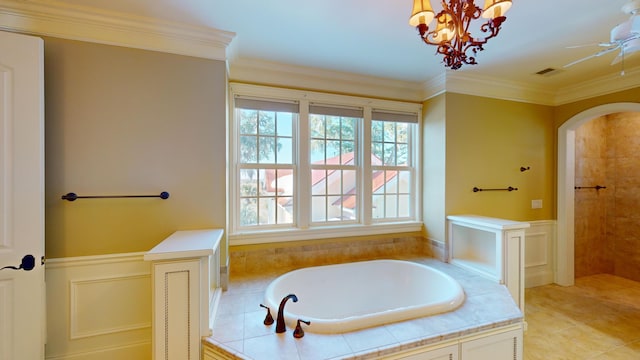 bathroom featuring ornamental molding, a chandelier, and a bathtub