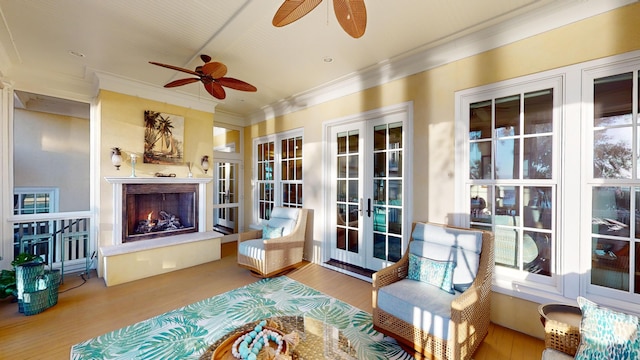 sunroom / solarium featuring a premium fireplace and french doors