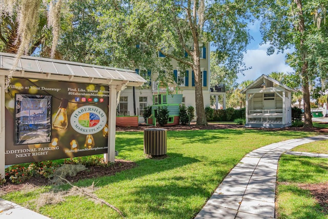 view of home's community with a yard