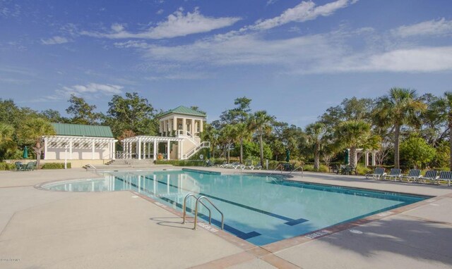 view of swimming pool with a pergola and a patio area