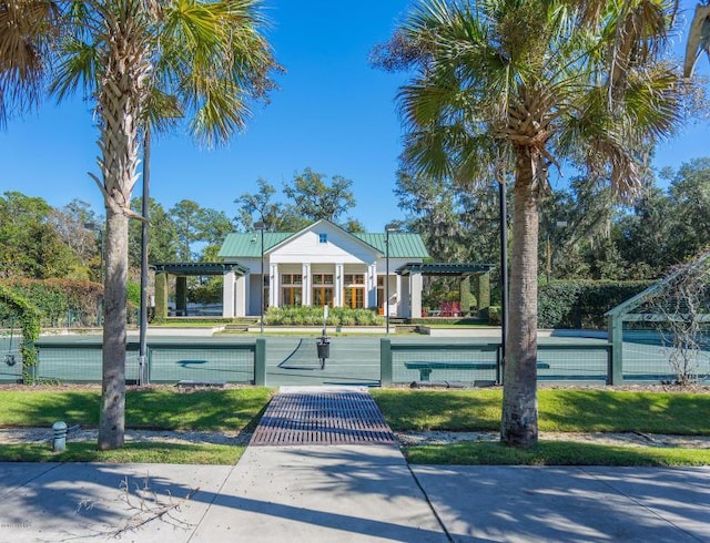 view of home's community with a yard and a pergola