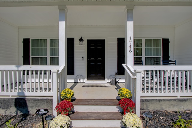 entrance to property featuring a porch