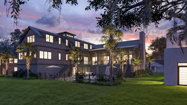 27 Rebellion Rd, Charleston, SC 29407 - back of house at dusk with a standing seam roof, a chimney, and metal roof