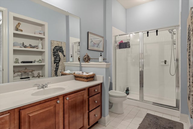 bathroom with vanity, a shower with shower door, toilet, and tile patterned flooring