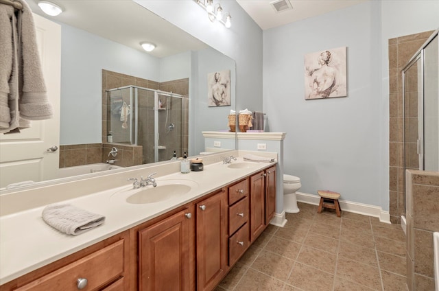 bathroom featuring vanity, tile patterned floors, a shower with shower door, and toilet